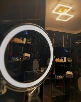 a mirror reflection of a room with plants on a wall at RosaM Suite - Via Veneto 15 min walk from Spanish Steps Top Floor Luxury Apartment in Rome