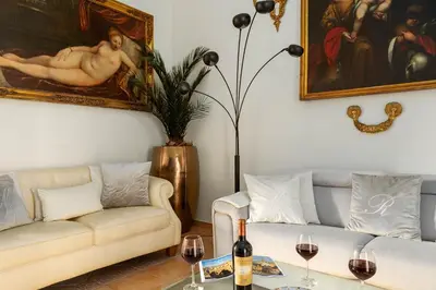 a living room with two couches and a table with wine glasses at RosaM Suite - Via Veneto 15 min walk from Spanish Steps Top Floor Luxury Apartment in Rome