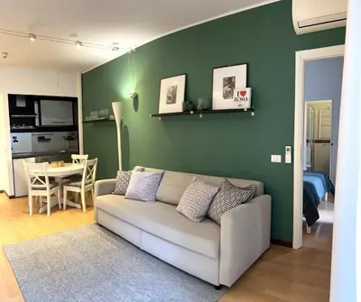 a living room with a couch and a table at Villa Borghese Green Apartment in Rome