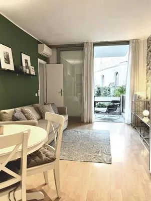 a living room with a couch and a table at Villa Borghese Green Apartment in Rome