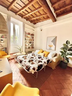 a bedroom with a bed and a couch in a room at Oasi di relax a Trastevere in Rome
