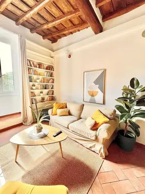 a living room with a couch and a table at Oasi di relax a Trastevere in Rome