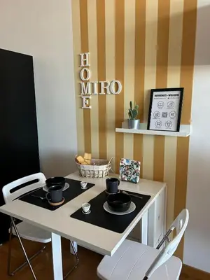a dining room table with two chairs and a microwave at Miro Home II in Rome