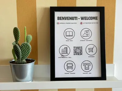 a framed sign on a shelf with a cactus at Miro Home II in Rome