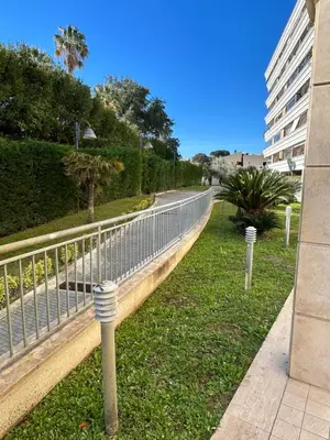 a fence in the grass next to a building at Miro Home II in Rome