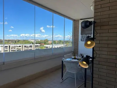 a table and chair in front of a large window at Miro Home II in Rome