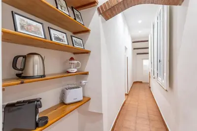 a corridor of a room with wooden shelves at 2 BDR Navona Quintessential Charm in Rome