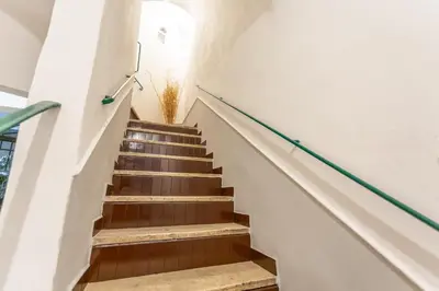 a staircase in a building with a plant at 2 BDR Navona Quintessential Charm in Rome