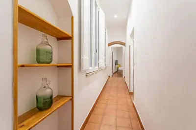 a hallway with two bottles on shelves and a window at 2 BDR Navona Quintessential Charm in Rome
