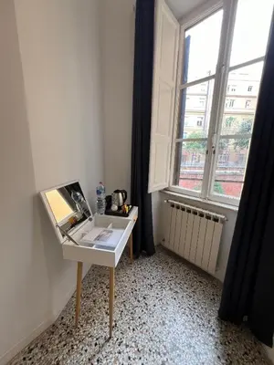 a desk in a room with a large window at Luxury room Anelli center of Roma in Rome