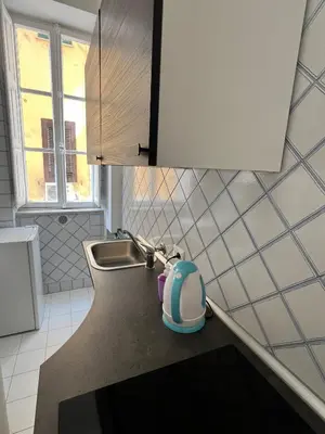 a small kitchen with a sink and a vacuum at Luxury room Anelli center of Roma in Rome