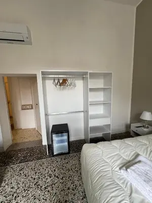 a bedroom with a bed and a tv in it at Luxury room Anelli center of Roma in Rome