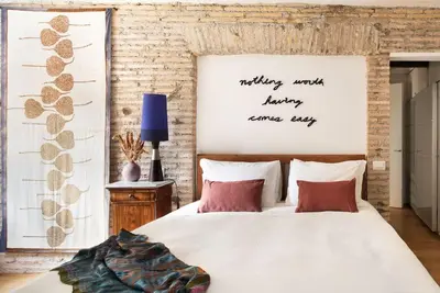 a bedroom with a large white bed with red pillows at Idyllia - Cozy central retreat in Trastevere in Rome