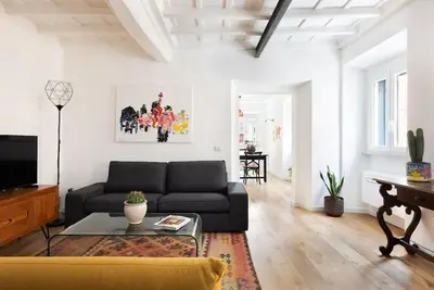 a living room with a couch and a table at Idyllia - Cozy central retreat in Trastevere in Rome