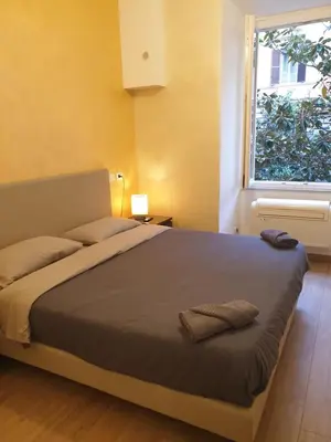 a bedroom with a large bed with a window at Lombardo in Rome