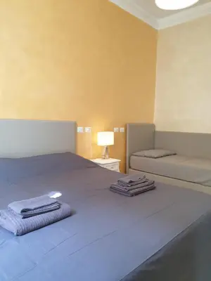 a bedroom with a bed with two towels on it at Lombardo in Rome