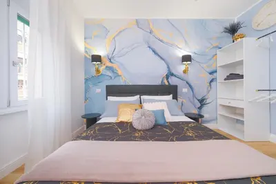 a bedroom with a bed with a blue wall at The blue Iris in Rome