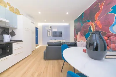 a kitchen and living room with a vase on a table at The blue Iris in Rome