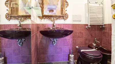 a bathroom with two sinks and a toilet at Sibylla in Rome in Rome
