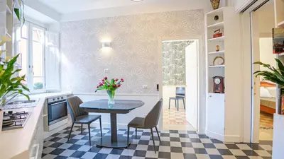 a kitchen with a table and chairs in a room at Sibylla in Rome in Rome