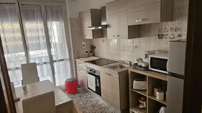 a small kitchen with a sink and a microwave at casa Aldini in Rome