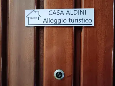 a sign on a door that reads casa albuquerque albuquerque university at casa Aldini in Rome