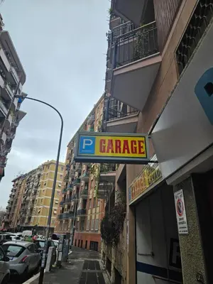 a sign for a garage on the side of a building at casa Aldini in Rome