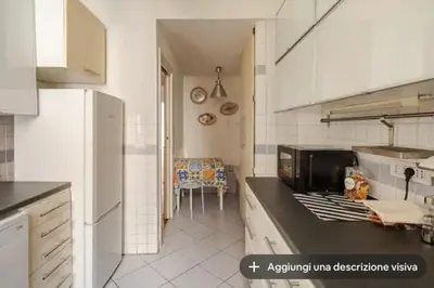 a kitchen with white cabinets and a counter top at SAN PIETRO VATICAN AREA LARGE APARTMENT - near SUBWAY in Rome