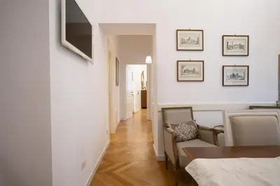 a living room with white walls and a table and chairs at Domus Alba Mantua in Rome