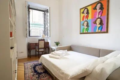 a bedroom with a bed and a painting on the wall at Domus Alba Mantua in Rome