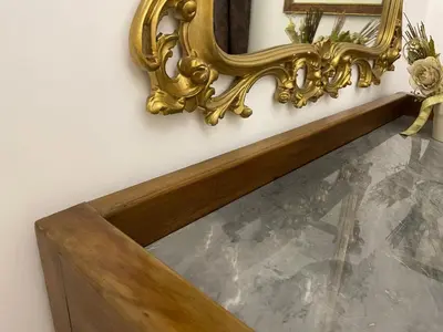 a gold mirror on a wall next to a stairway at Domus Alba Mantua in Rome