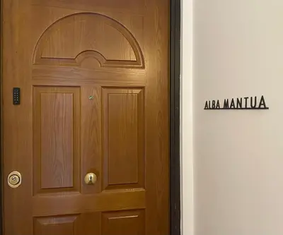 a wooden door with aania marmite sign next to it at Domus Alba Mantua in Rome