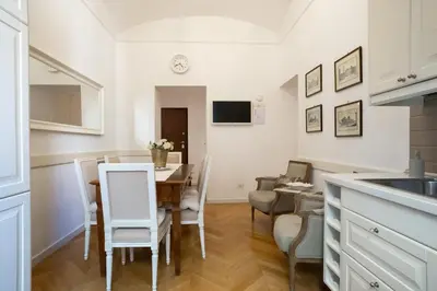 a kitchen and dining room with a table and chairs at Domus Alba Mantua in Rome