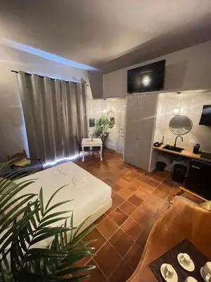 a room with a bed and a desk in it at Lucilla’s Suite San Pietro station in Rome