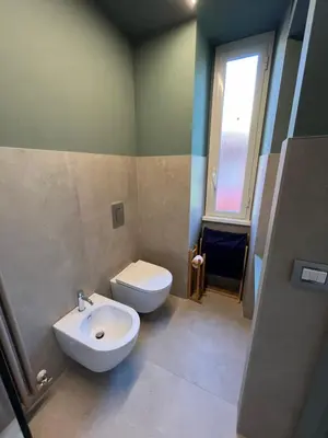 a bathroom with a white toilet and a sink at CARPE DIEM Ponte Milvio Olimpico Farnesina in Rome