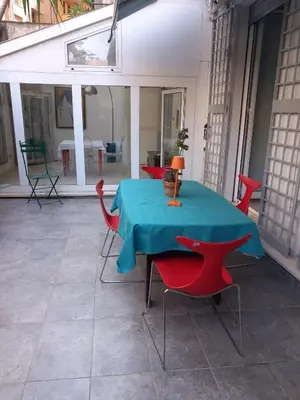 a table with red chairs and a blue table cloth at Salotto Sommer San Pietro in Rome