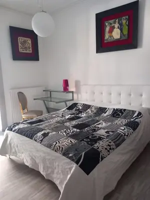 a bedroom with a bed with a black and white quilt at Salotto Sommer San Pietro in Rome
