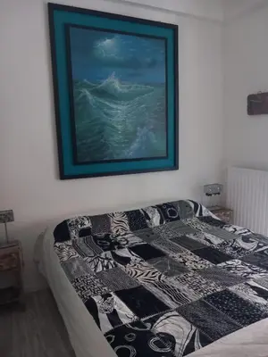 a bed in a bedroom with a picture on the wall at Salotto Sommer San Pietro in Rome