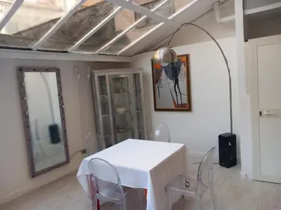 a bedroom with a bed with a black and white quilt at Salotto Sommer San Pietro in Rome