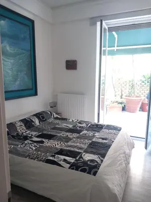 a bedroom with a bed with a blanket on it at Salotto Sommer San Pietro in Rome