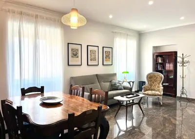 a living room with a table and a couch at 4BNB - Leone IV Apartment in Rome