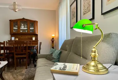 a living room with a green lamp on a table at 4BNB - Leone IV Apartment in Rome