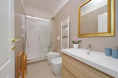 a bathroom with a sink and a toilet and a mirror at 4BNB - Leone IV Apartment in Rome