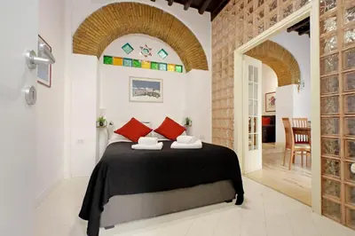 a bedroom with a bed with red pillows at 4BNB - Lungaretta Jacuzzi Apartment in Rome