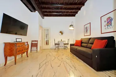 a living room with a couch and a table at 4BNB - Lungaretta Jacuzzi Apartment in Rome