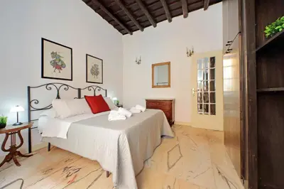 a bedroom with a bed and a table and a window at 4BNB - Lungaretta Jacuzzi Apartment in Rome
