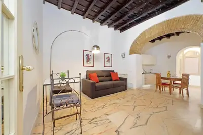 a living room with a couch and a table at 4BNB - Lungaretta Jacuzzi Apartment in Rome