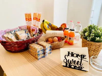 a table with a basket of food and a home sweet home sign at Al Mamalo Rome Luxury Apartment in Rome