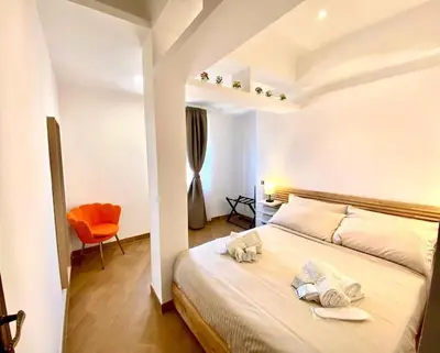 a bedroom with a bed with towels on it at Al Mamalo Rome Luxury Apartment in Rome
