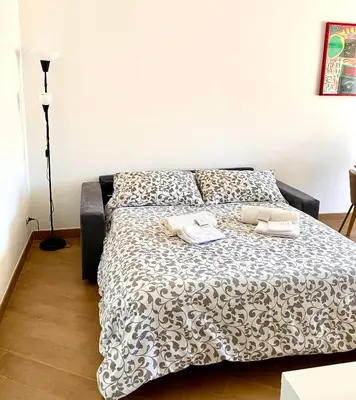 a bedroom with a bed with two towels on it at Al Mamalo Rome Luxury Apartment in Rome